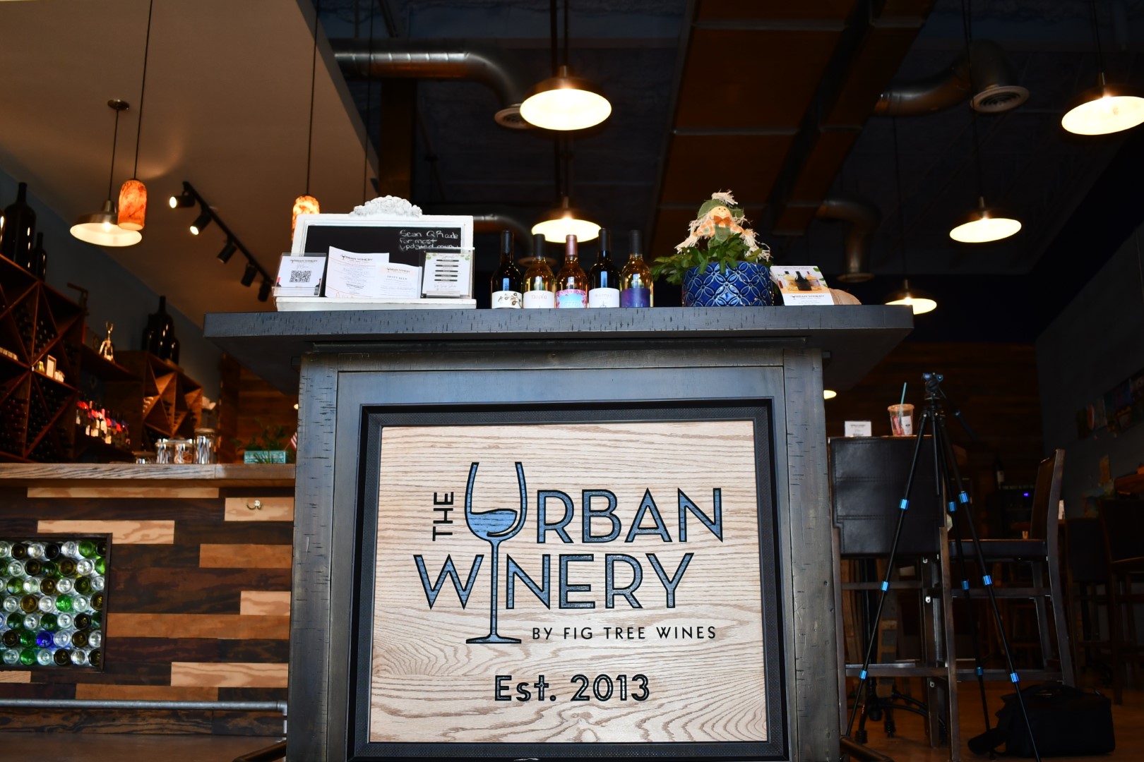  A podium with Urban Winery sign stands in front of the reception area.